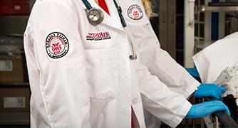 Photo of closeup of students badge on lab coat